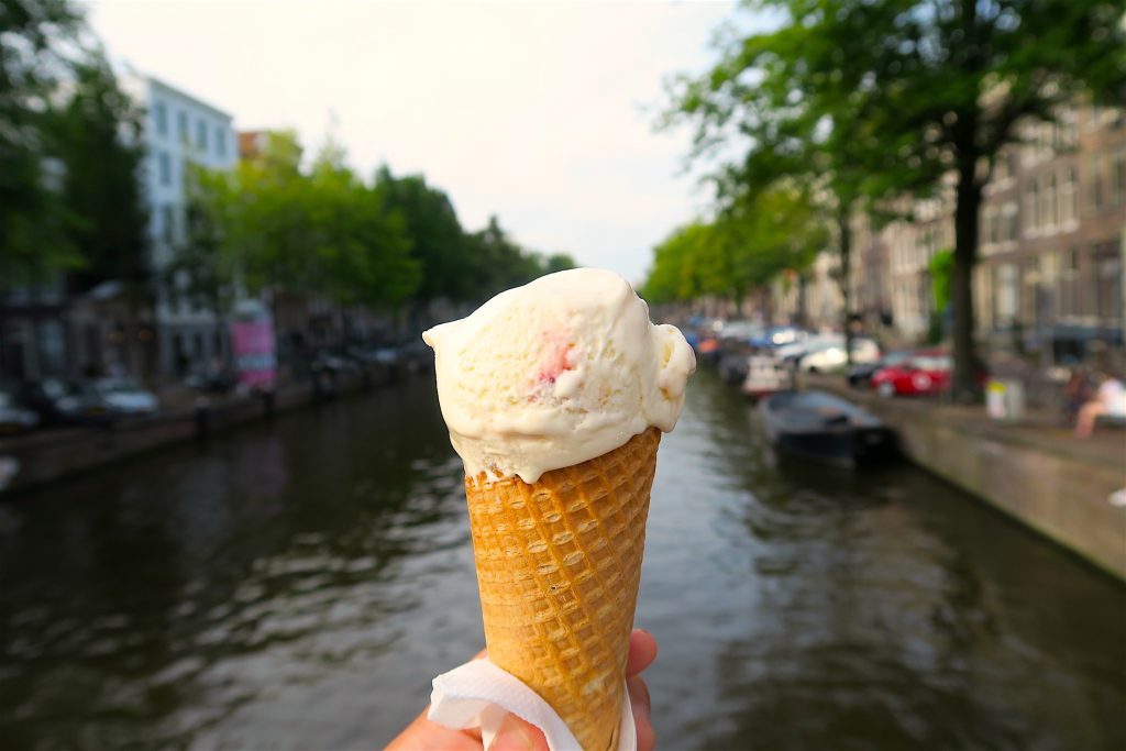 A scoop of strawberry cheese cake flavored ice cream
